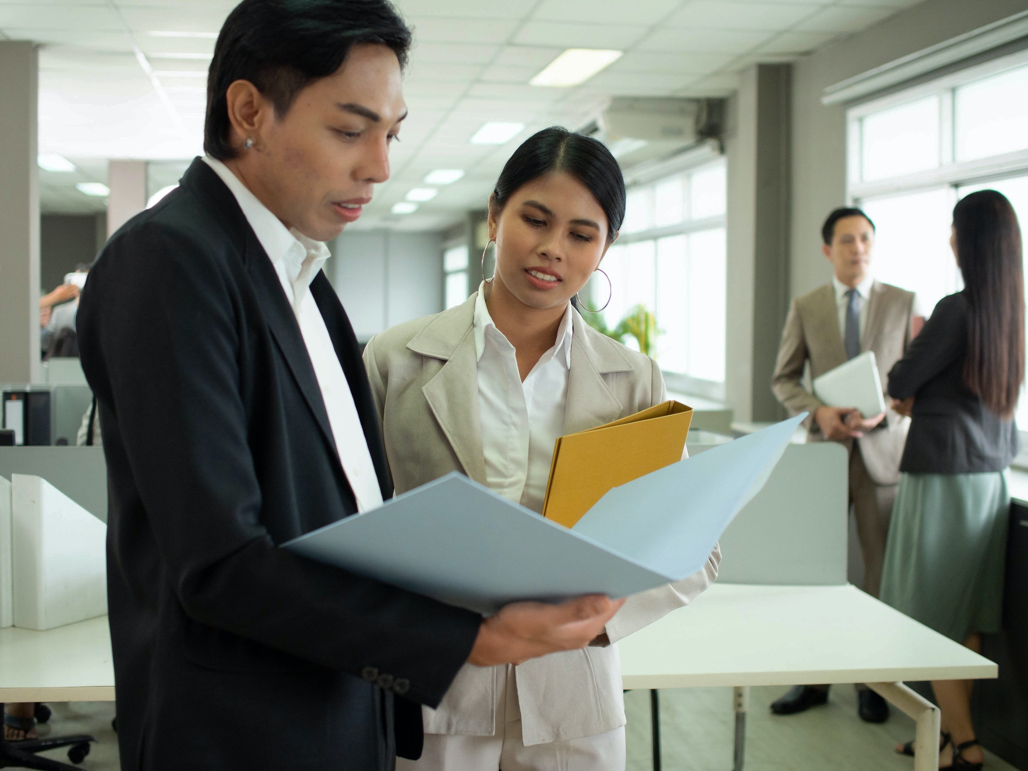 Businesswoman and businessman manager boss executive company office look at report sale file